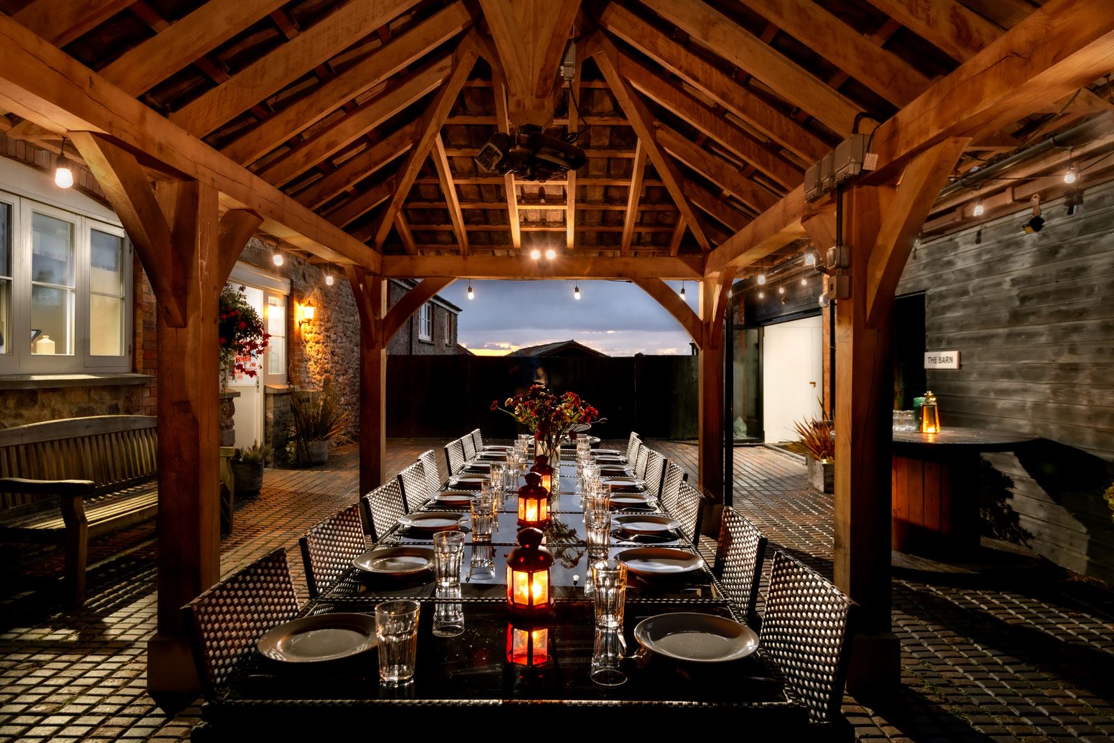 A luxurious under cover outside dining area for a large group at Webbington Farm Cottages near Weston-super-Mare